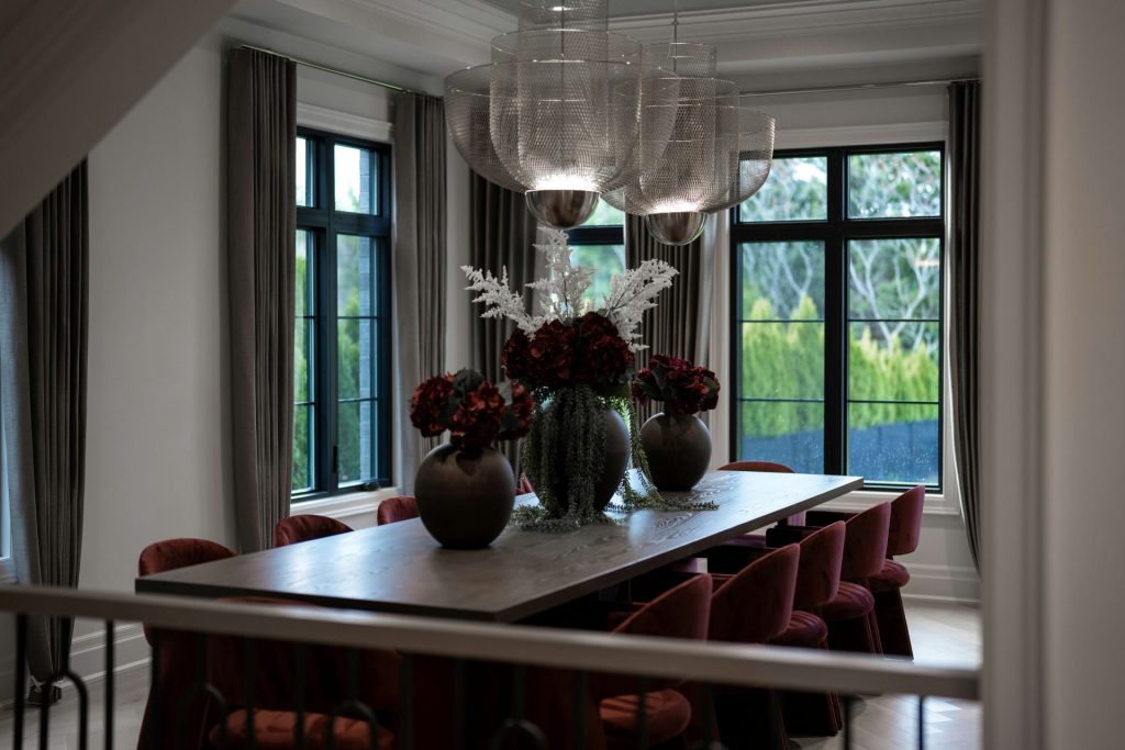 Elegant dining room with large table and red chairs
