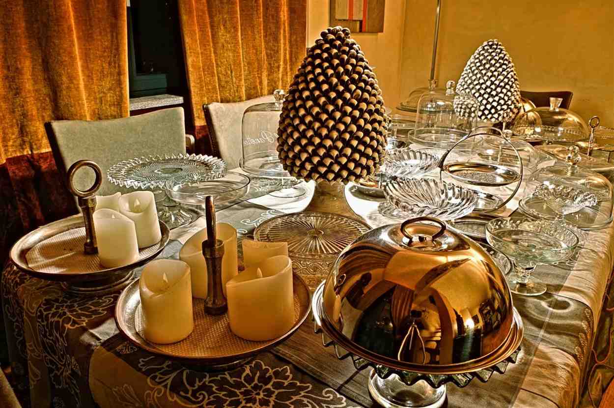 A dining room table is set with dishes and candles